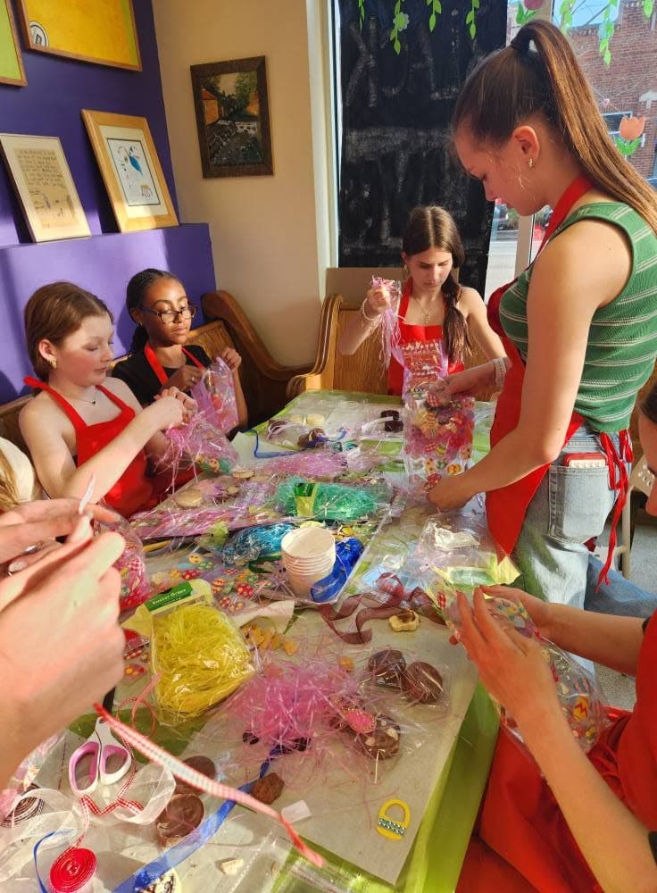 Students wrapping their handmade chocolates during a class